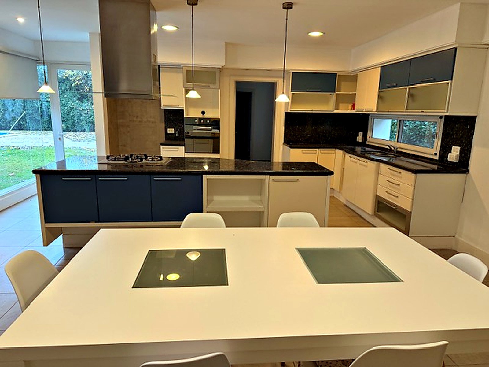 Open kitchen with granite island and navy cabinets